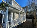 Side view of a charming home with a covered porch and white railing at 3210 Linden Dr, Lawrenceville, GA 30044