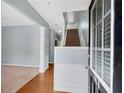Inviting foyer with hardwood floors, staircase, and decorative wall trim at 111 Riverstone Commons Cir, Canton, GA 30114