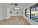 A spacious living room featuring hardwood floors, large windows, and freshly painted white walls at 2358 Tilson Rd, Decatur, GA 30032