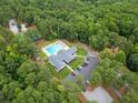 Aerial view of community amenities featuring a large pool, tennis court, and ample parking at 5527 Centry Dr, Villa Rica, GA 30180