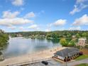 Scenic aerial view of lakefront community with beach, lake access, and well-maintained buildings at 5527 Centry Dr, Villa Rica, GA 30180