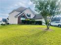 Lovely home with a sprawling green lawn and mature trees, great for outdoor activities at 15 Emerson Trl, Covington, GA 30016
