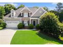 Charming two-story home featuring a manicured lawn and brick and gray siding at 1539 School House Run, Dacula, GA 30019