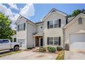 Inviting exterior view showcasing a well-maintained townhome with black shutters, attached garage, and tidy landscaping at 1362 Rogers Trce, Lithonia, GA 30058