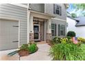 Inviting front entrance with a covered porch and well-maintained landscaping and American flag at 1530 Parkside Village Dr, Cumming, GA 30040