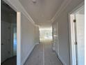 Bright hallway featuring white trim, fresh paint, and doors leading to various rooms at 5381 Tuscany Dr, Douglasville, GA 30135