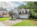 Two-story home featuring an attached two car garage and a well maintained lawn at 3604 Cameron Hills Pl, Ellenwood, GA 30294