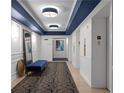 Elegant hallway featuring custom lighting, paneled walls, and stylish blue accents at 199 14Th Ne St # 3003, Atlanta, GA 30309