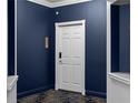 Intimate hallway area leading to suite entrance with dark blue wall and white trim at 199 14Th Ne St # 3003, Atlanta, GA 30309
