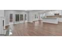 Spacious living room featuring hardwood floors, fireplace, and sliding glass doors to the backyard at 250 Stonecreek Pkwy, Covington, GA 30016