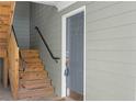 Property entrance featuring wooden stairs and a steel front door at 1102 Madison Se Ln # 1102, Smyrna, GA 30080