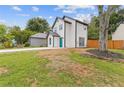 Exterior view of a white two story home with a bright blue front door and green grass at 1164 Red Oak Cv, Tucker, GA 30084