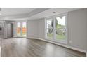 Bright living room features hardwood floors, large windows, and access to backyard at 1164 Red Oak Cv, Tucker, GA 30084