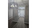 Hallway view leading to modern kitchen with white cabinets and countertops at 3201 Fairington Dr, Lithonia, GA 30038