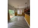 Cozy breakfast nook featuring wood-look floors, a sliding door to a deck, and backyard view at 3324 Whitmore Ct, Acworth, GA 30101