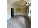 Bright dining room with modern flooring, chandelier, wainscotting, and large windows at 3324 Whitmore Ct, Acworth, GA 30101