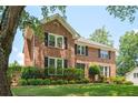 Attractive brick home with a lush green lawn, black shutters, and mature trees offering curb appeal at 2251 Rushmore Dr, Marietta, GA 30062