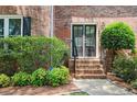 Elegant front entrance of brick home with decorative shrubs and well-maintained landscaping at 2251 Rushmore Dr, Marietta, GA 30062