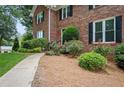 Welcoming walkway leads to this brick home with mature landscaping and charming black shutters at 2251 Rushmore Dr, Marietta, GA 30062