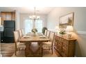 Bright dining room with a large wooden table set for eight, and a rustic sideboard at 914 Hemingway Rd, Stone Mountain, GA 30088