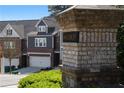 Woodbury community entrance sign with brick pillar and view of townhomes at 2736 Bell Se Dr, Smyrna, GA 30080