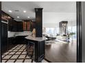 Open concept living room showcasing black cabinetry, marble countertops and floor to ceiling windows at 3475 Oak Valley Ne Rd # 2820, Atlanta, GA 30326