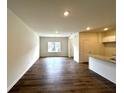 Open-concept living area with hardwood floors and abundant natural light at 1909 Victoria Way # 116, Conyers, GA 30013