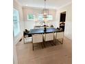 Well-lit dining room featuring a modern chandelier and stylish furniture at 410 Anglin Walk, Alpharetta, GA 30009
