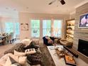 Comfortable living room with large windows, fireplace, and stylish decor at 410 Anglin Walk, Alpharetta, GA 30009