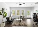 Bright living room with contemporary decor, hardwood floors, and a ceiling fan at 1190 Buice Lake Pkwy, Acworth, GA 30102
