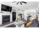 Open-concept living room flows into modern kitchen, featuring a fireplace and comfortable seating at 1190 Buice Lake Pkwy, Acworth, GA 30102
