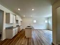 An open-concept kitchen featuring white cabinets, granite countertops, and a central island, ideal for entertaining at 1911 Victoria Way # 117, Conyers, GA 30013