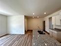 Modern kitchen with granite countertops, an island with sink, and sleek cabinets, perfect for any home chef at 1911 Victoria Way # 117, Conyers, GA 30013