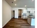 Bright living area featuring modern flooring, ample natural light, and open access to the kitchen space at 1911 Victoria Way # 117, Conyers, GA 30013