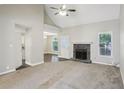 Spacious living room features a vaulted ceiling, a stone fireplace, and abundant natural light at 1945 Grayson Oaks Ct, Lawrenceville, GA 30045