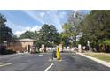 Gated entrance to a neighborhood, with security features, and surrounding trees at 4701 Flat Shoals Rd # 68D, Union City, GA 30291