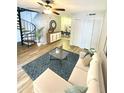 Staged living room showcases a cozy sofa and open access to the dining area at 4701 Flat Shoals Rd # 68D, Union City, GA 30291