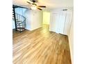 Spacious living area featuring wood-look flooring and a unique spiral staircase at 4701 Flat Shoals Rd # 68D, Union City, GA 30291