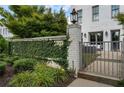 Charming front entrance with a private, ivy-covered wall and an iron gate, adding curb appeal to this property at 323 S Esplanade, Alpharetta, GA 30009
