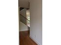 Inviting entryway featuring hardwood floors and staircase with iron railing at 341 Bailey Walk, Alpharetta, GA 30009