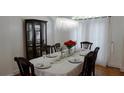 Dining room with chandelier lighting, dark wood furniture and hardwood floors at 10785 Arlington Pt, Alpharetta, GA 30022