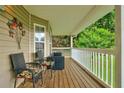 Inviting front porch with stylish seating, ideal for enjoying the outdoor views and relaxing moments at 1137 Eagles Nest Cir, Carrollton, GA 30116