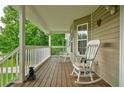 Cozy front porch featuring classic rocking chairs and wood flooring, perfect for relaxation at 1137 Eagles Nest Cir, Carrollton, GA 30116