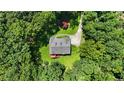 Aerial view of brick home nestled in a lush, green wooded lot at 1950 Lower Burris Rd, Canton, GA 30114