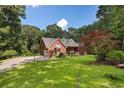 Beautiful brick home with dormers and a well-maintained lawn at 1950 Lower Burris Rd, Canton, GA 30114