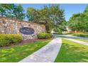 Stone community sign for Trillium Forest with lush landscaping and sidewalk at 3677 Trillium Forest Dr, Snellville, GA 30039