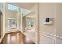 Bright foyer with hardwood floors, soaring ceilings, and wainscoting at 3677 Trillium Forest Dr, Snellville, GA 30039