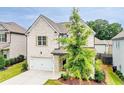 Charming two-story home with white brick, an attached garage, landscaped yard, and inviting covered front porch at 1250 Grove Pkwy, Jonesboro, GA 30236