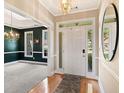 Welcoming foyer with hardwood floors, a chandelier, and views into the dining room at 3072 Oaktree Ln, Duluth, GA 30096