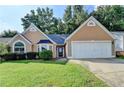 Charming home with a well-manicured lawn and two-car garage at 3625 Ennfield Lane Ln, Duluth, GA 30096